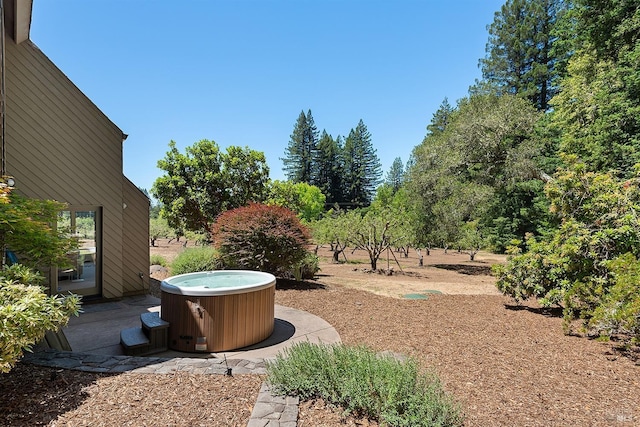 view of yard featuring a hot tub, cooling unit, and a patio area