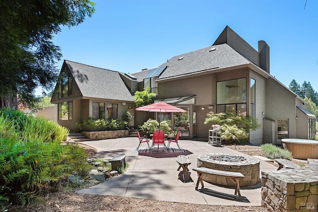 back of house with a patio area and a fire pit