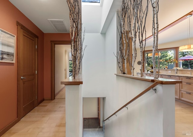 corridor with light hardwood / wood-style flooring