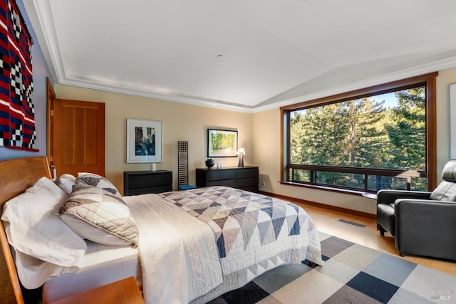 bedroom with vaulted ceiling and ornamental molding