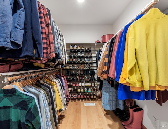 walk in closet featuring hardwood / wood-style flooring