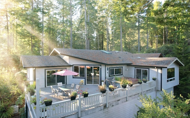 back of house featuring a wooden deck