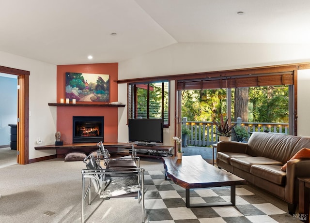 living room with carpet, plenty of natural light, and vaulted ceiling