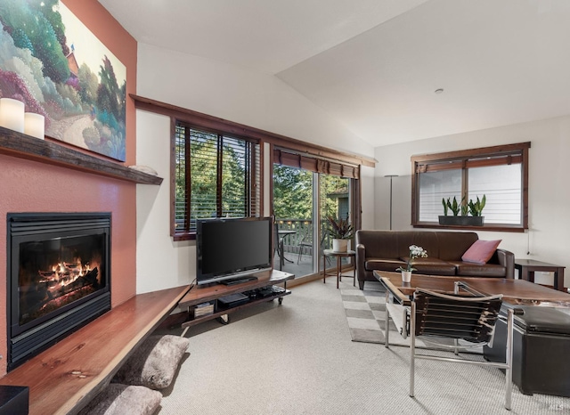 living room featuring light colored carpet and vaulted ceiling