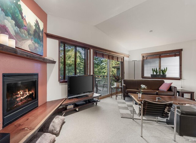 21995 Ansel Ct, Timber Cove, CA 95450 - carpeted living area with a glass covered fireplace and lofted ceiling