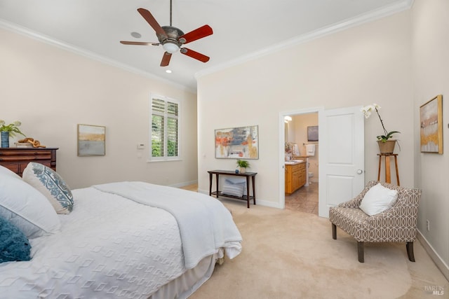 bedroom with connected bathroom, light colored carpet, a ceiling fan, baseboards, and crown molding