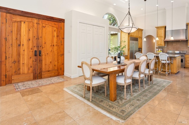 dining space featuring arched walkways, light tile patterned floors, recessed lighting, a towering ceiling, and ornamental molding