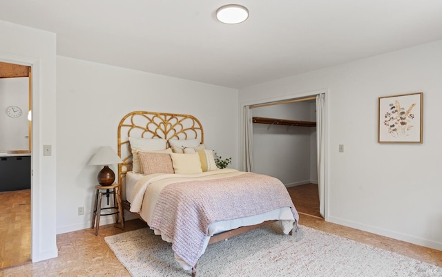 bedroom with a closet and baseboards