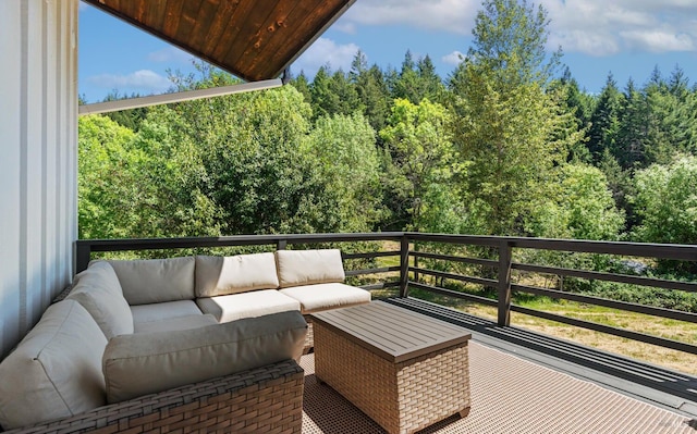 balcony with a wooded view and outdoor lounge area