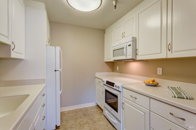 kitchen featuring white cabinets, white appliances, and sink