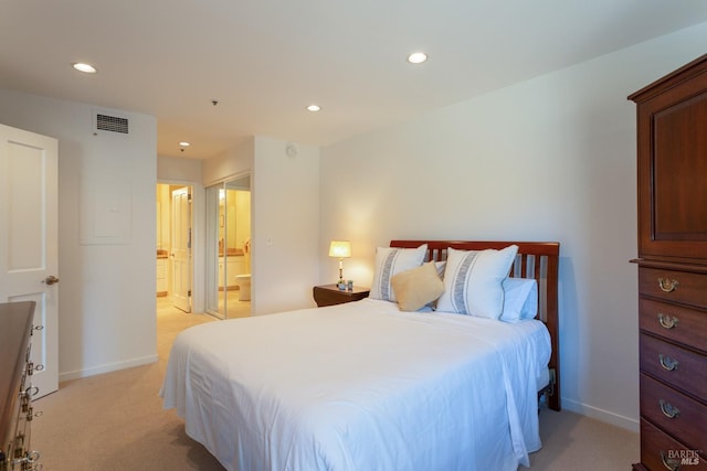 carpeted bedroom featuring ensuite bath