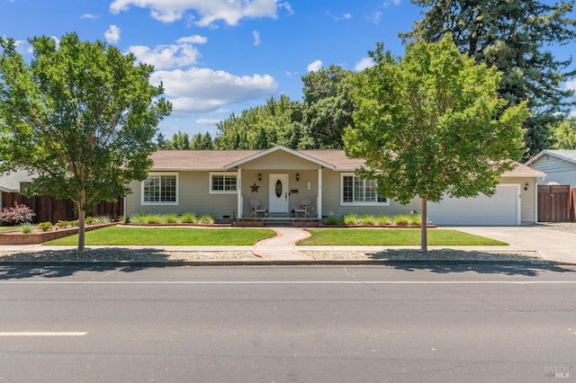 ranch-style home with a garage and a front lawn