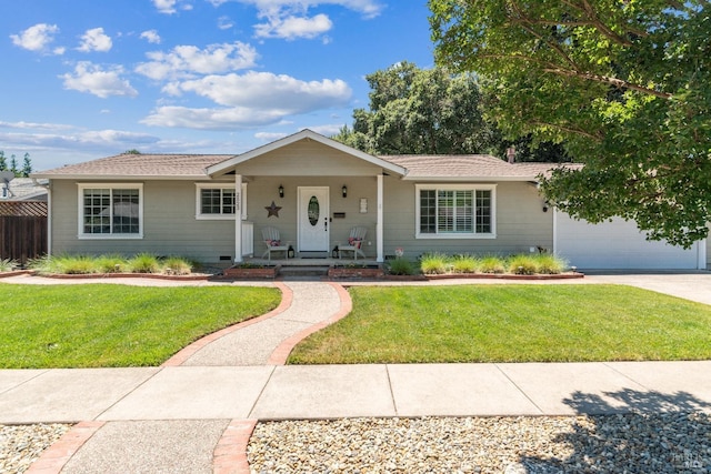 ranch-style house featuring a garage, covered porch, and a front yard