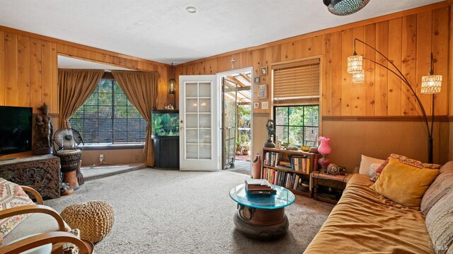 living room with wood walls and carpet flooring