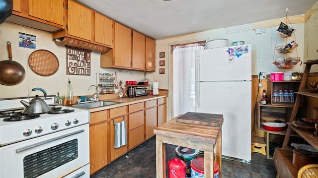 kitchen featuring white appliances and sink