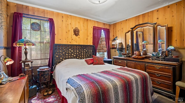 bedroom featuring wooden walls, multiple windows, and crown molding