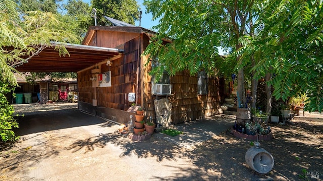 view of property exterior featuring a carport