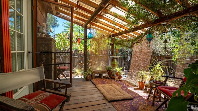 sunroom featuring lofted ceiling with beams