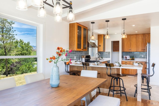 dining area featuring light wood-type flooring and sink