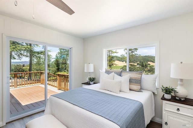 bedroom featuring access to outside, ceiling fan, and hardwood / wood-style floors