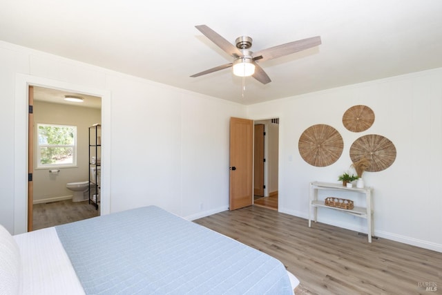 bedroom with hardwood / wood-style floors, connected bathroom, ceiling fan, and crown molding