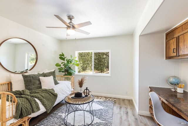 sitting room featuring light wood-type flooring, a wealth of natural light, crown molding, and ceiling fan