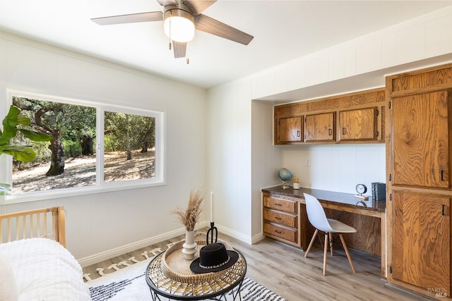 home office with ceiling fan, light wood-type flooring, and crown molding