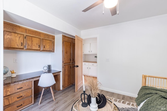 office space featuring light hardwood / wood-style flooring, ceiling fan, and crown molding