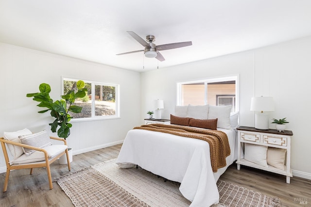 bedroom with hardwood / wood-style floors and ceiling fan