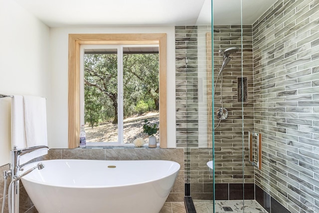 bathroom featuring separate shower and tub and tile walls