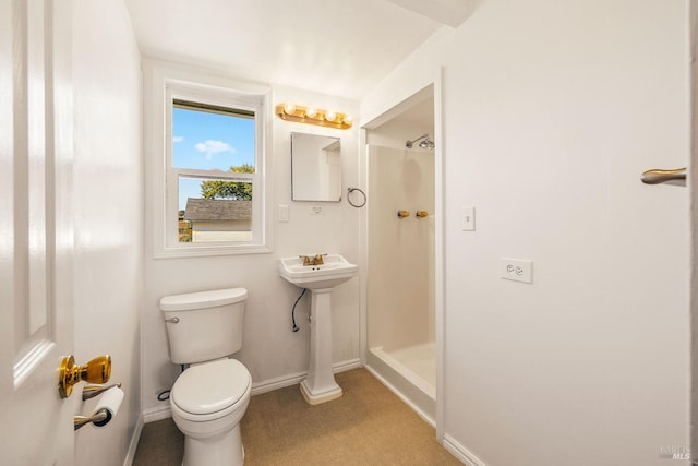 bathroom featuring toilet and a shower