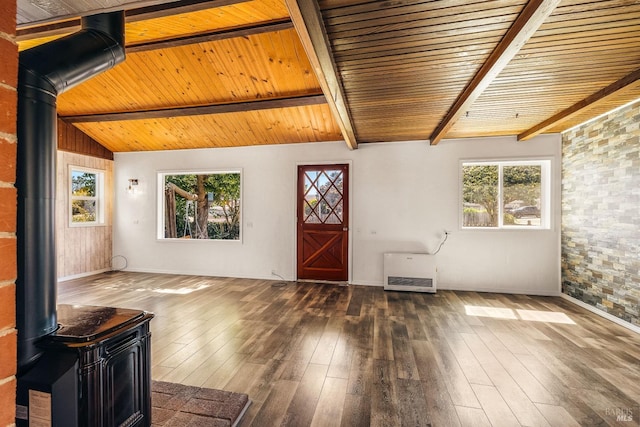 foyer featuring wooden ceiling, a healthy amount of sunlight, lofted ceiling with beams, and a wood stove