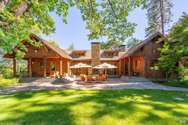 back of house with a patio area and a yard