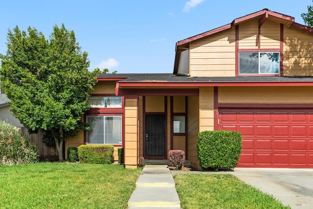 view of front of home featuring a garage and a front yard