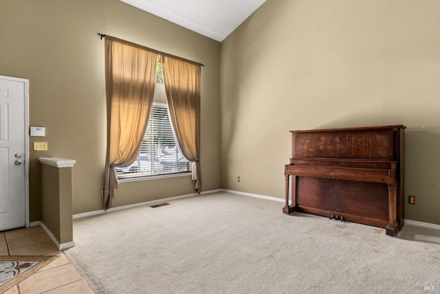 interior space featuring light colored carpet and vaulted ceiling