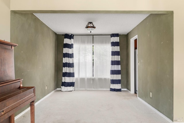 unfurnished room with light colored carpet