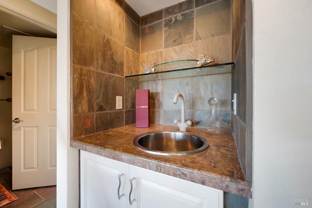 bathroom featuring vanity and backsplash