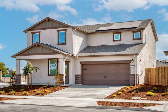 view of front facade featuring concrete driveway, roof mounted solar panels, fence, and roof with shingles