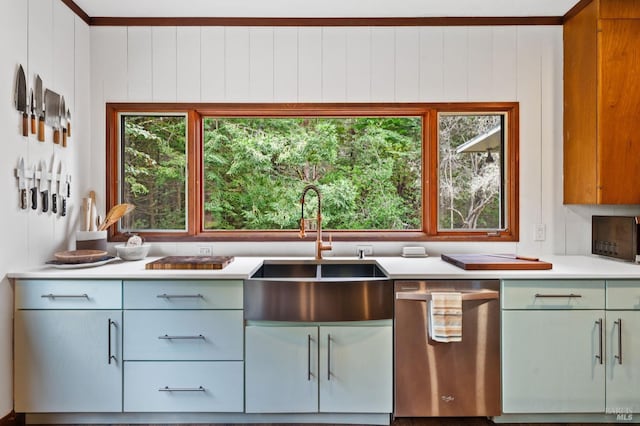 kitchen with crown molding, wood walls, stainless steel dishwasher, and sink