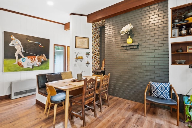 dining space with beam ceiling and light hardwood / wood-style floors