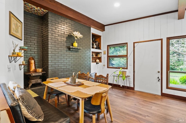 dining area with a wealth of natural light, wood-type flooring, and beam ceiling