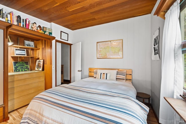 bedroom featuring wood ceiling, hardwood / wood-style flooring, and beam ceiling