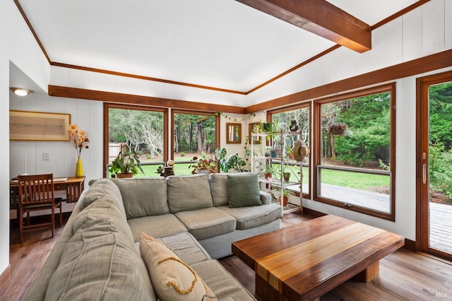 living room featuring crown molding, vaulted ceiling, and hardwood / wood-style floors