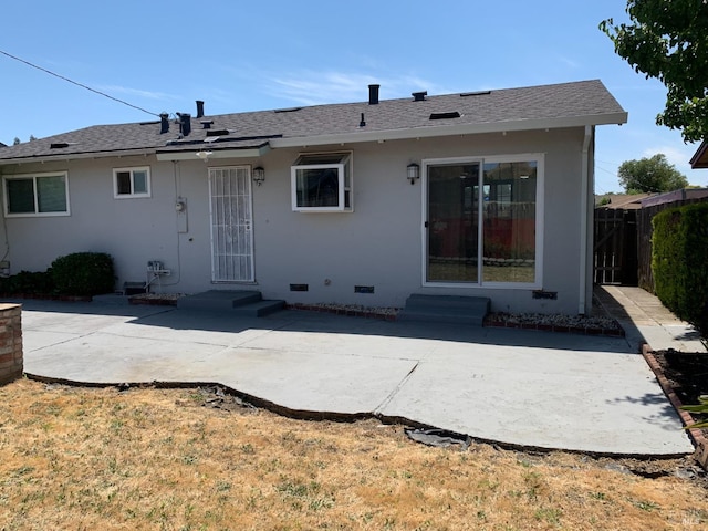 back of property with a patio