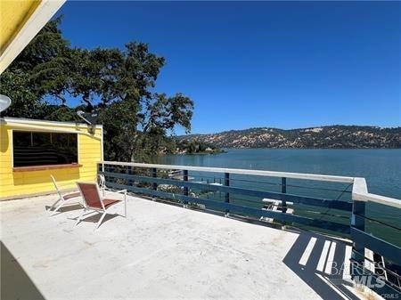 view of terrace featuring a balcony and a water view