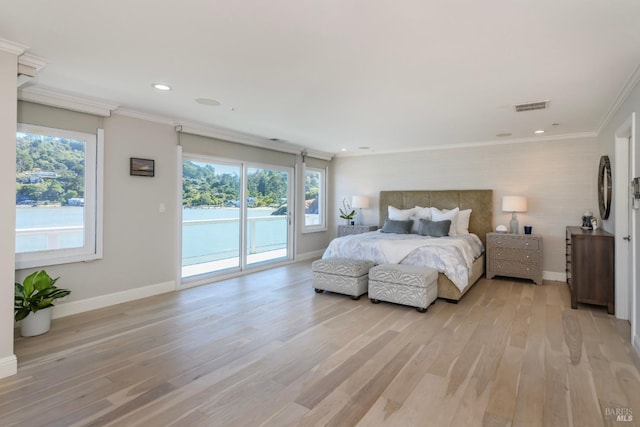 bedroom featuring multiple windows, access to exterior, ornamental molding, and light hardwood / wood-style floors