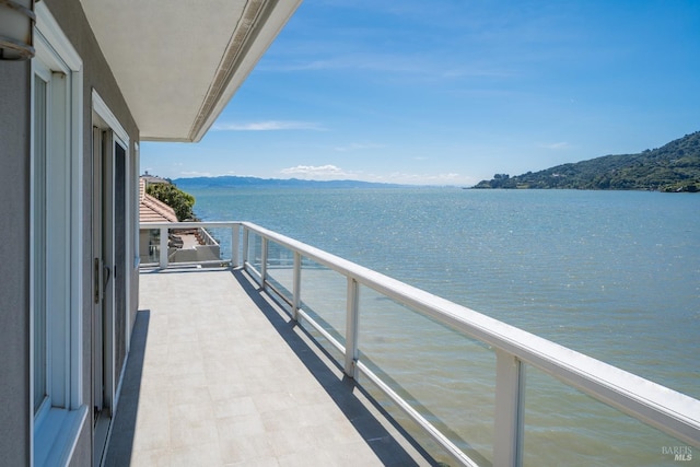 balcony with a water and mountain view