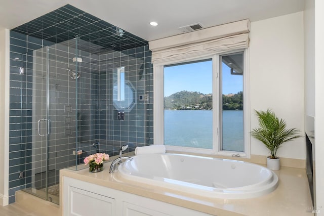 bathroom featuring a water view and plus walk in shower