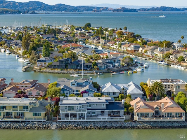 drone / aerial view featuring a water and mountain view