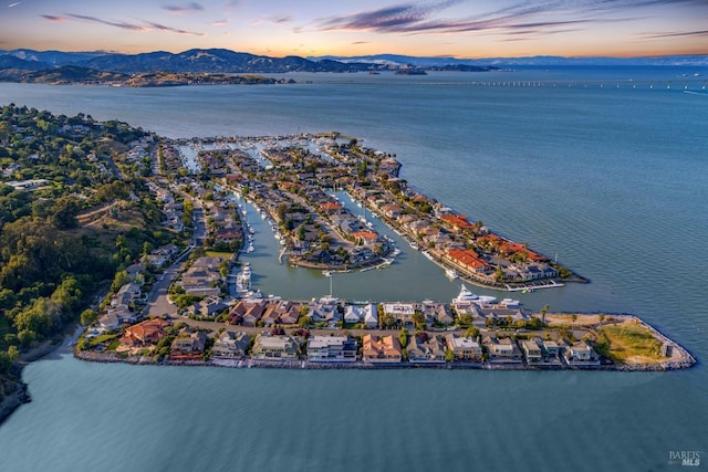 aerial view at dusk with a water and mountain view